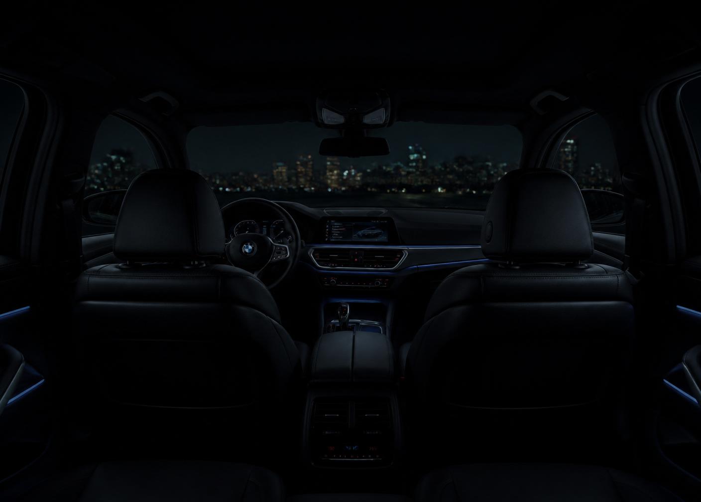 BMW interior at night with black leather and ambient lighting